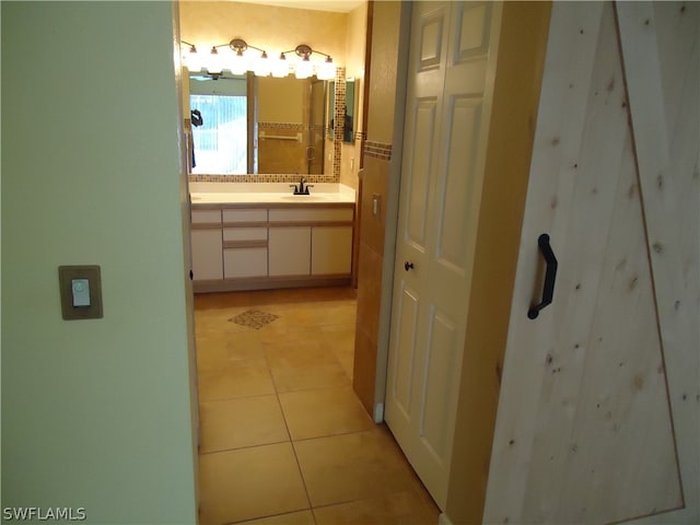 bathroom with tile patterned floors and vanity