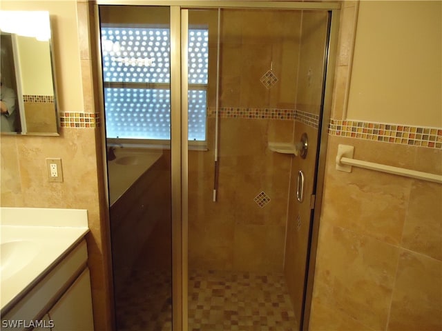 bathroom featuring vanity and a shower with door