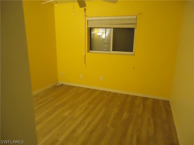 spare room featuring ceiling fan and hardwood / wood-style flooring