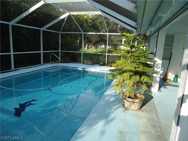 view of swimming pool with a lanai and a patio area