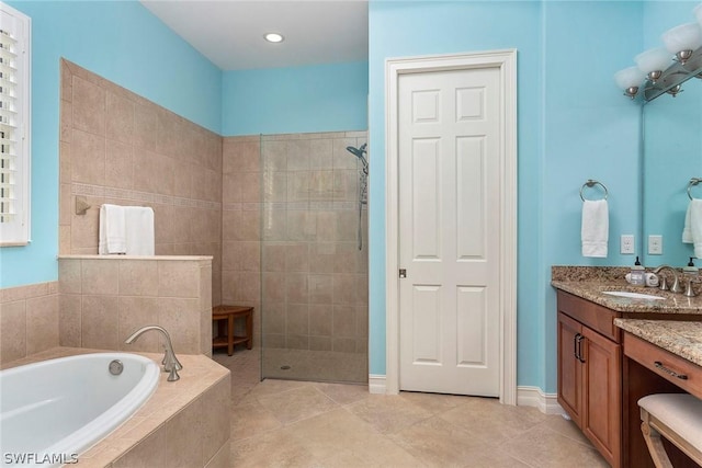 bathroom featuring tile patterned floors, separate shower and tub, and vanity