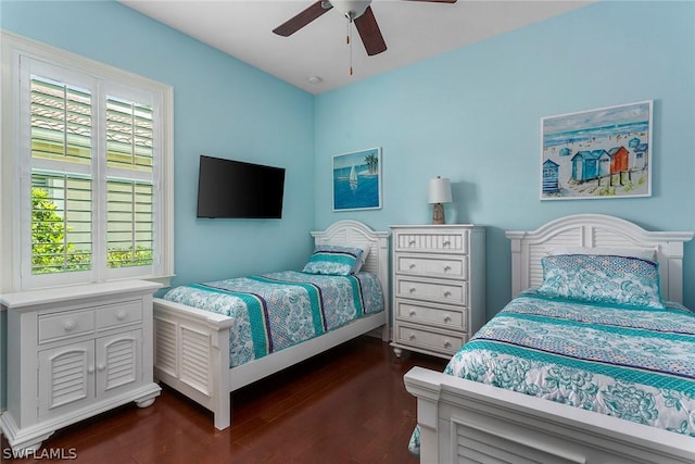 bedroom with ceiling fan and dark wood-type flooring