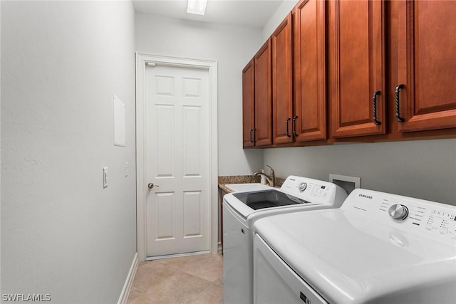 washroom with cabinets, sink, and separate washer and dryer