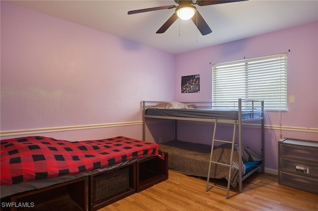 bedroom with light hardwood / wood-style floors and ceiling fan