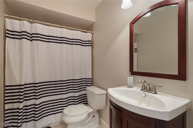 bathroom with toilet, vanity, and walk in shower