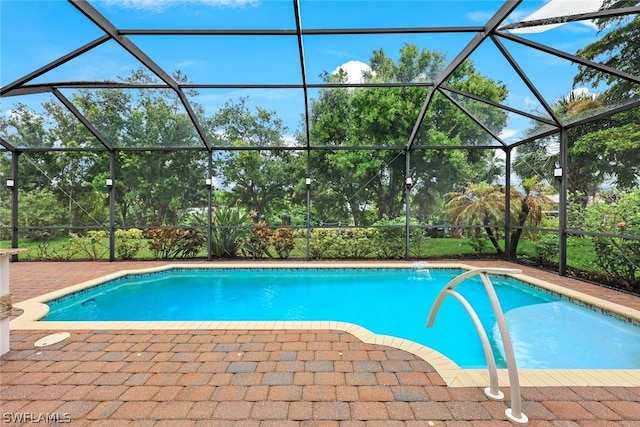 outdoor pool featuring a lanai and a patio area