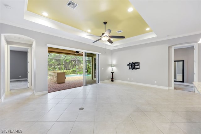 unfurnished room featuring visible vents, a tray ceiling, and crown molding