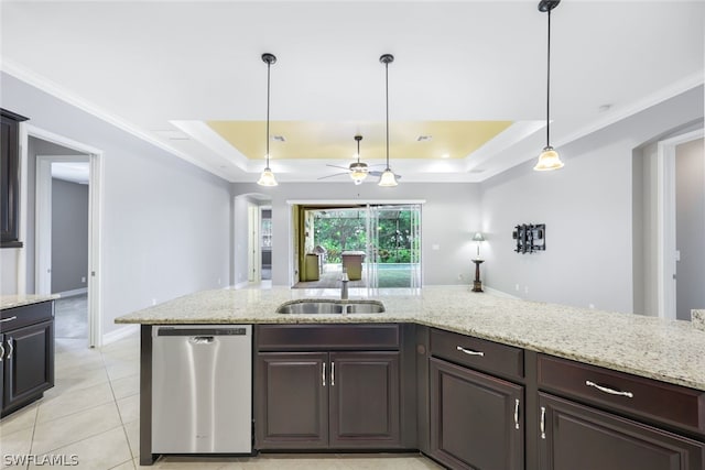 kitchen with a raised ceiling, stainless steel dishwasher, hanging light fixtures, and a sink