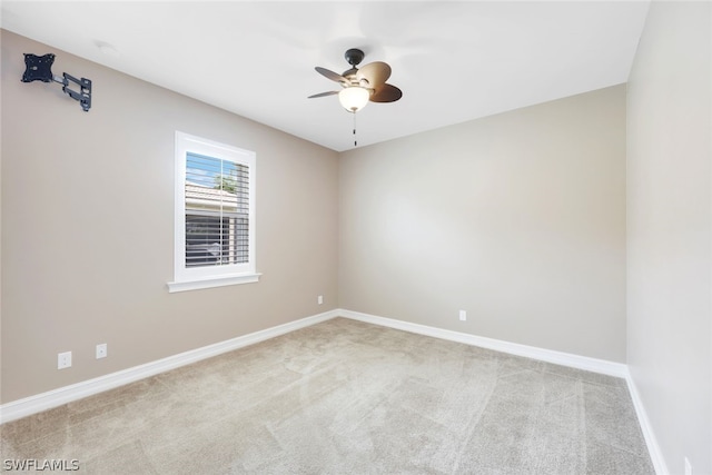 unfurnished room with light carpet, ceiling fan, and baseboards