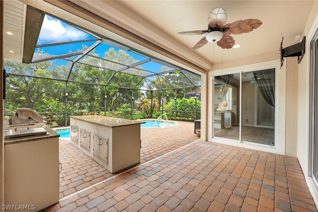 view of patio / terrace with a ceiling fan, a grill, an outdoor pool, and an outdoor kitchen