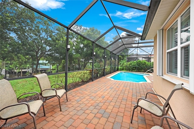 outdoor pool with a lanai and a patio area