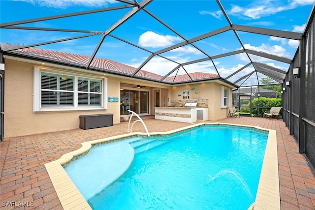 outdoor pool featuring glass enclosure, ceiling fan, and a patio
