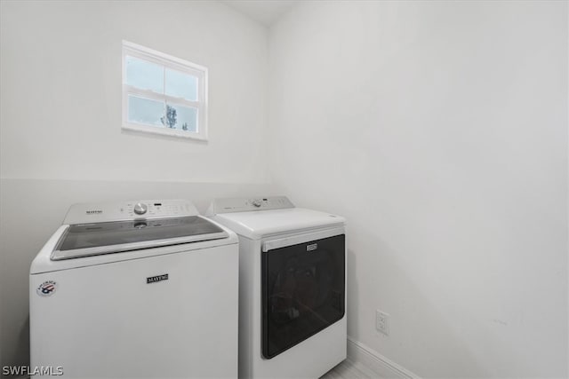 clothes washing area with washing machine and dryer