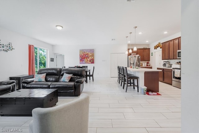 living room featuring sink and light tile patterned flooring