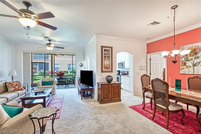 carpeted living room with ceiling fan with notable chandelier and crown molding