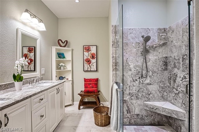 bathroom with a shower with shower door and vanity