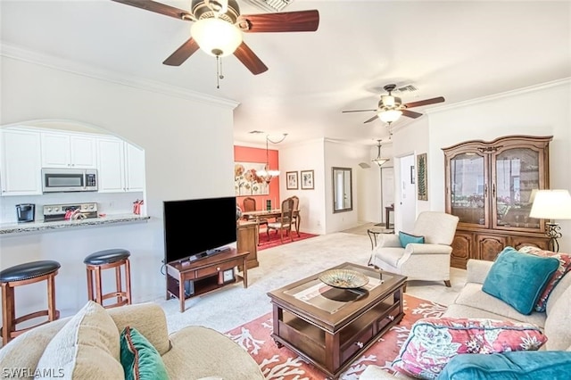 living room featuring ceiling fan, light colored carpet, and crown molding