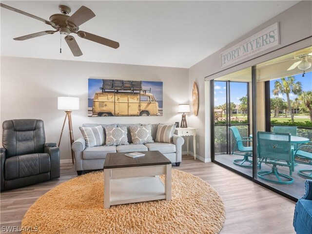 living room featuring ceiling fan and light wood-type flooring