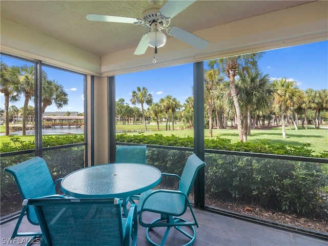 sunroom featuring ceiling fan