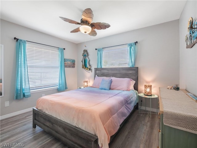 bedroom featuring multiple windows, ceiling fan, and dark wood-type flooring