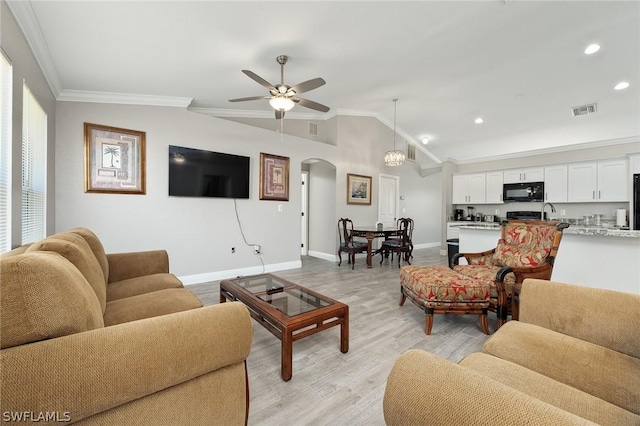 living room with ceiling fan, sink, light hardwood / wood-style flooring, crown molding, and lofted ceiling