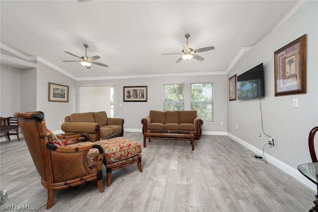 living room featuring crown molding, plenty of natural light, lofted ceiling, and light wood-type flooring