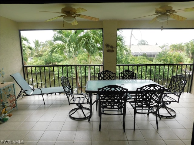 sunroom / solarium featuring ceiling fan