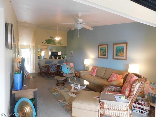 carpeted living room with ceiling fan