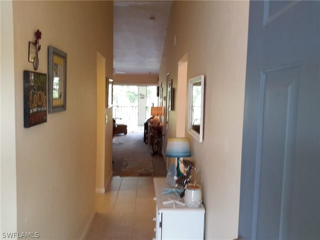 hall with light tile patterned floors