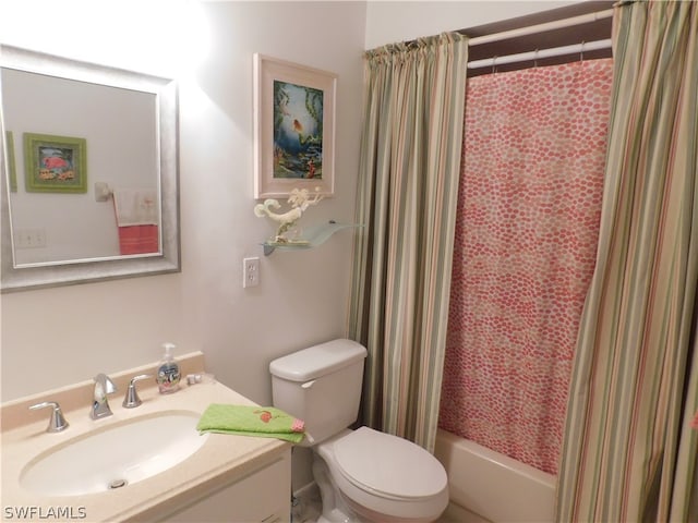 full bathroom featuring toilet, shower / bath combination with curtain, and vanity