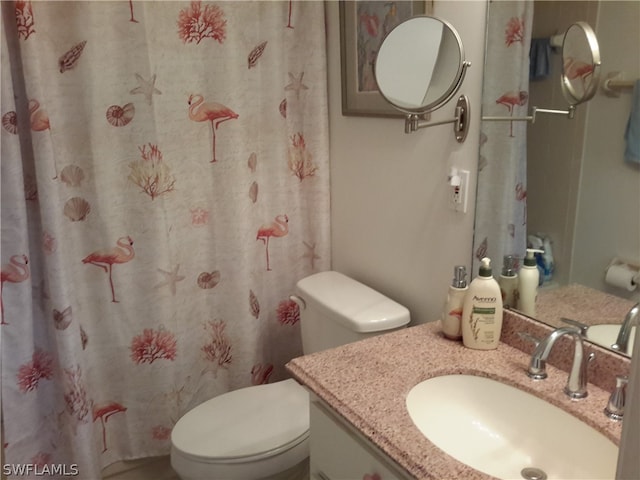 bathroom featuring vanity and toilet