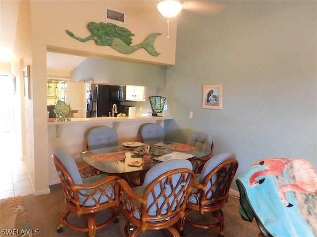 tiled dining space featuring sink and ceiling fan