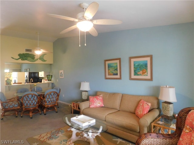 carpeted living room with ceiling fan