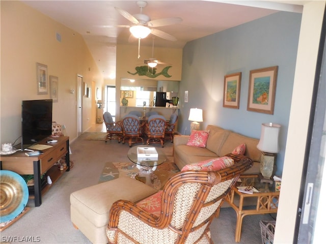 carpeted living room with lofted ceiling and ceiling fan