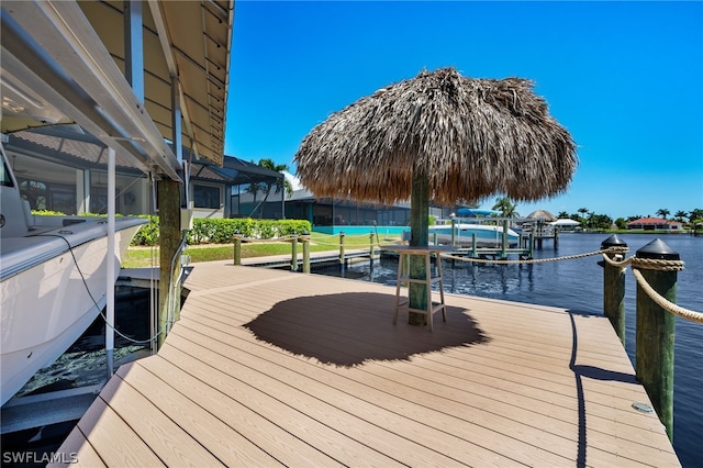 view of dock featuring a water view and a lanai