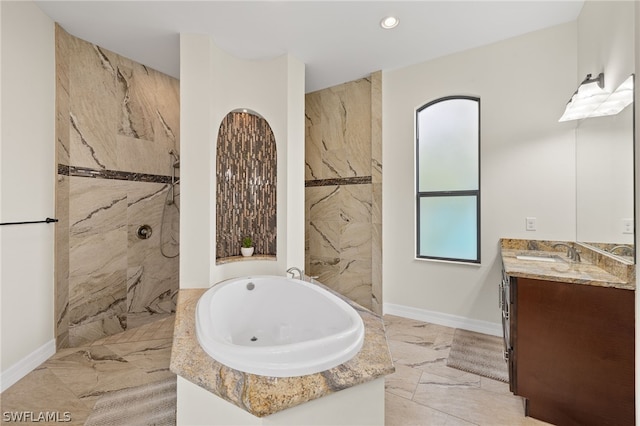 bathroom featuring vanity and shower with separate bathtub