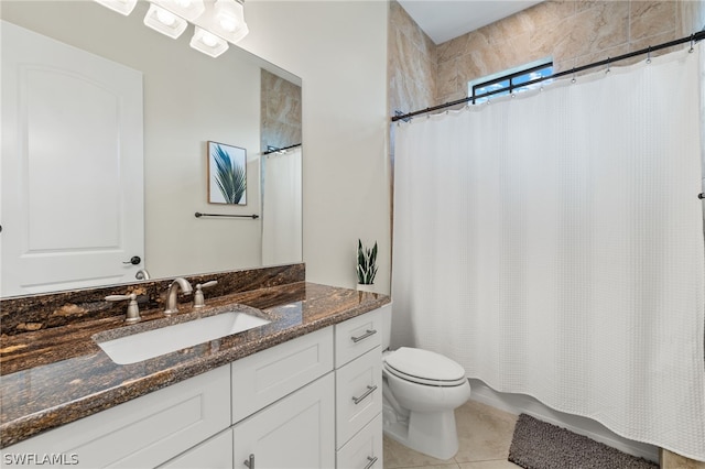 bathroom featuring tile patterned floors, toilet, and vanity