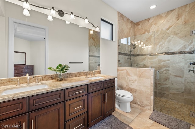 bathroom with tile patterned floors, vanity, toilet, and an enclosed shower