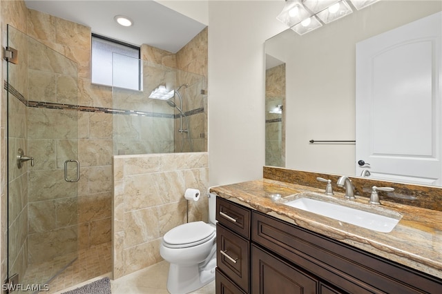 bathroom with vanity, tile patterned flooring, a shower with shower door, and toilet