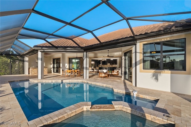 view of pool with an in ground hot tub, ceiling fan, a lanai, and a patio area