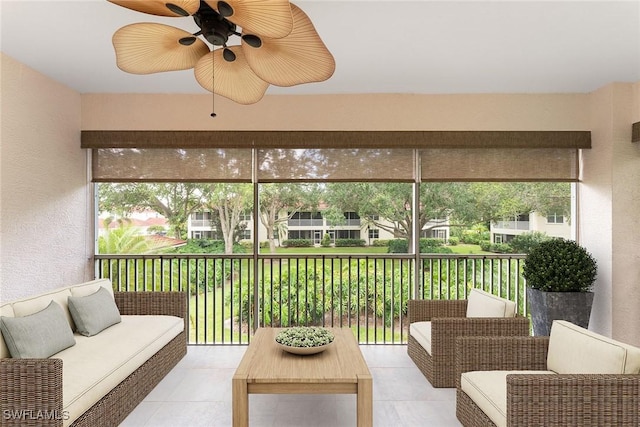 sunroom / solarium with a healthy amount of sunlight and a ceiling fan