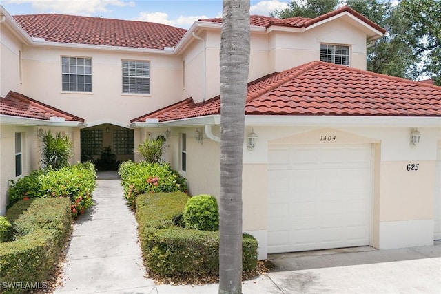 mediterranean / spanish house with a tile roof and stucco siding