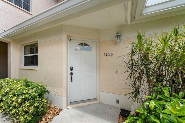 doorway to property with stucco siding