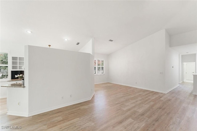 unfurnished living room featuring light wood-style flooring, baseboards, and visible vents