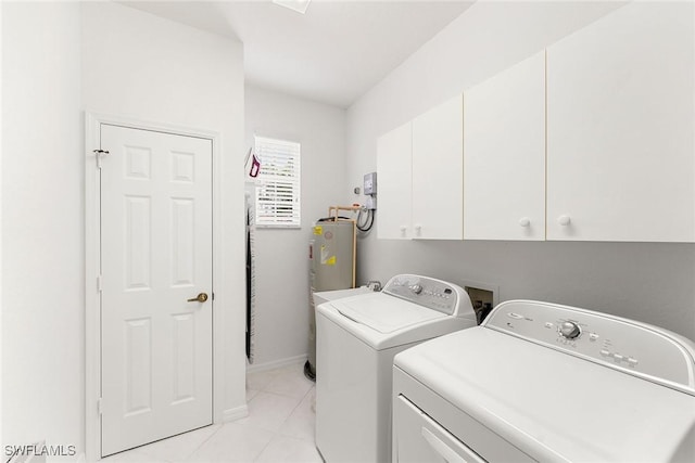 laundry area featuring baseboards, light tile patterned flooring, cabinet space, water heater, and washer and dryer