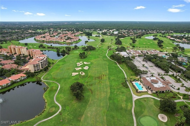drone / aerial view with a water view and view of golf course