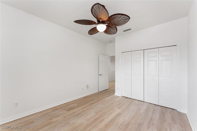 unfurnished bedroom with visible vents, a closet, light wood-style floors, baseboards, and ceiling fan
