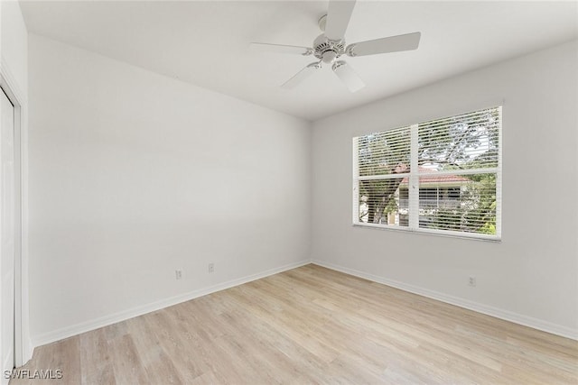 unfurnished room featuring light wood finished floors, ceiling fan, and baseboards