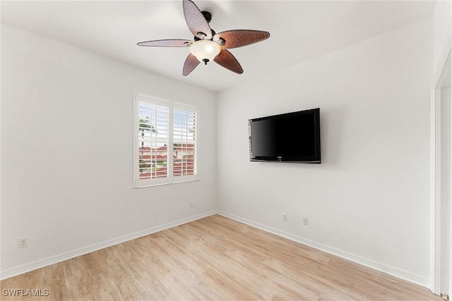 empty room featuring ceiling fan, baseboards, and light wood-style flooring
