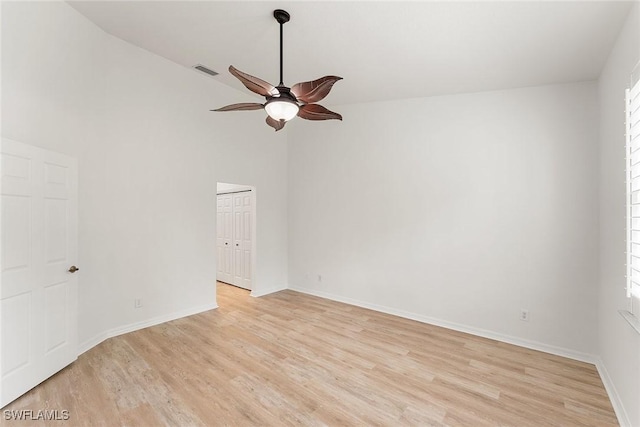 unfurnished room featuring a ceiling fan, baseboards, visible vents, and light wood finished floors